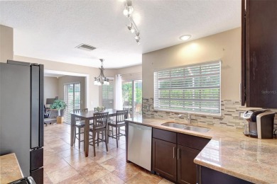 Welcome to this lovingly maintained 4-bedroom, 2.5-bath home on Hunters Green Country Club in Florida - for sale on GolfHomes.com, golf home, golf lot