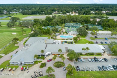 This end-unit villa condominium offers scenic golf course views on Spruce Creek Golf Club in Florida - for sale on GolfHomes.com, golf home, golf lot