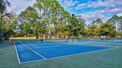 Welcome to this lovingly maintained 4-bedroom, 2.5-bath home on Hunters Green Country Club in Florida - for sale on GolfHomes.com, golf home, golf lot