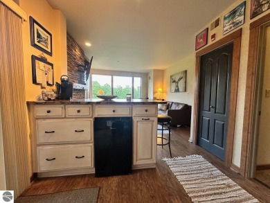 Fully furnished corner unit at the Lodge at Cedar River Village on Cedar River Golf Course in Michigan - for sale on GolfHomes.com, golf home, golf lot