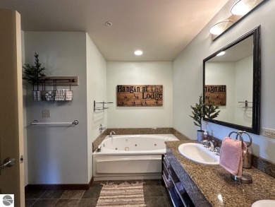 Fully furnished corner unit at the Lodge at Cedar River Village on Cedar River Golf Course in Michigan - for sale on GolfHomes.com, golf home, golf lot