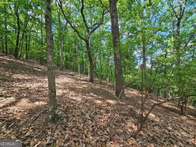Nestled within the serene and exclusive Big Canoe community in on Big Canoe Golf Club - Cherokee in Georgia - for sale on GolfHomes.com, golf home, golf lot