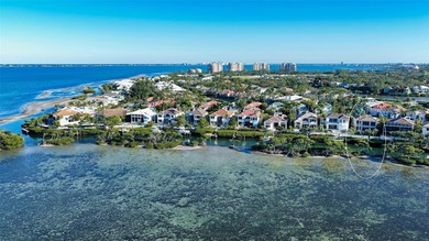 Located within the gated Queens Harbour enclave in Bay Isles on Longboat Key Golf Club Resort in Florida - for sale on GolfHomes.com, golf home, golf lot