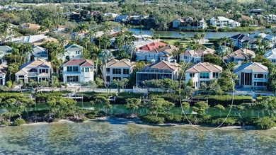 Located within the gated Queens Harbour enclave in Bay Isles on Longboat Key Golf Club Resort in Florida - for sale on GolfHomes.com, golf home, golf lot