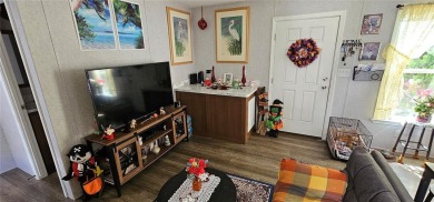 This charming 2022 Factory Expo Direct Park Model sits on one of on Glen Lakes Country Club in Florida - for sale on GolfHomes.com, golf home, golf lot