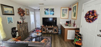 This charming 2022 Factory Expo Direct Park Model sits on one of on Glen Lakes Country Club in Florida - for sale on GolfHomes.com, golf home, golf lot