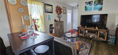 This charming 2022 Factory Expo Direct Park Model sits on one of on Glen Lakes Country Club in Florida - for sale on GolfHomes.com, golf home, golf lot