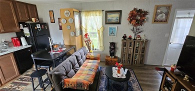 This charming 2022 Factory Expo Direct Park Model sits on one of on Glen Lakes Country Club in Florida - for sale on GolfHomes.com, golf home, golf lot