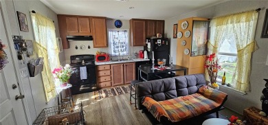 This charming 2022 Factory Expo Direct Park Model sits on one of on Glen Lakes Country Club in Florida - for sale on GolfHomes.com, golf home, golf lot