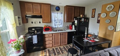 This charming 2022 Factory Expo Direct Park Model sits on one of on Glen Lakes Country Club in Florida - for sale on GolfHomes.com, golf home, golf lot