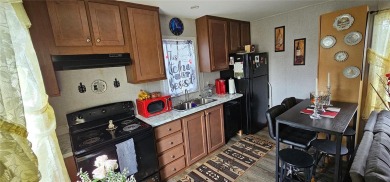 This charming 2022 Factory Expo Direct Park Model sits on one of on Glen Lakes Country Club in Florida - for sale on GolfHomes.com, golf home, golf lot