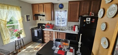 This charming 2022 Factory Expo Direct Park Model sits on one of on Glen Lakes Country Club in Florida - for sale on GolfHomes.com, golf home, golf lot