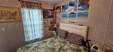 This charming 2022 Factory Expo Direct Park Model sits on one of on Glen Lakes Country Club in Florida - for sale on GolfHomes.com, golf home, golf lot