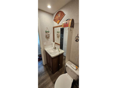 This charming 2022 Factory Expo Direct Park Model sits on one of on Glen Lakes Country Club in Florida - for sale on GolfHomes.com, golf home, golf lot