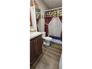 This charming 2022 Factory Expo Direct Park Model sits on one of on Glen Lakes Country Club in Florida - for sale on GolfHomes.com, golf home, golf lot