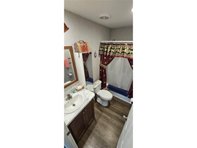 This charming 2022 Factory Expo Direct Park Model sits on one of on Glen Lakes Country Club in Florida - for sale on GolfHomes.com, golf home, golf lot