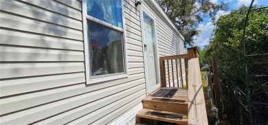 This charming 2022 Factory Expo Direct Park Model sits on one of on Glen Lakes Country Club in Florida - for sale on GolfHomes.com, golf home, golf lot
