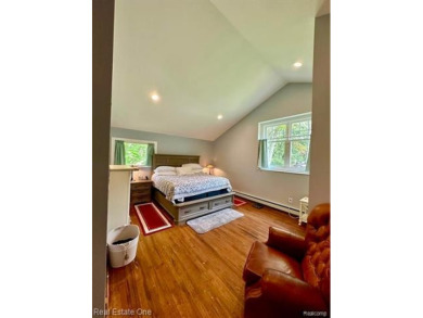 Presenting a beautifully remodeled Craftsman-style home that on Orchard Lake Country Club in Michigan - for sale on GolfHomes.com, golf home, golf lot