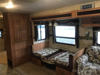 This 2008 31' Jayco RV w/ a custom-built covered structure on The Tillery Tradition Country Club in North Carolina - for sale on GolfHomes.com, golf home, golf lot