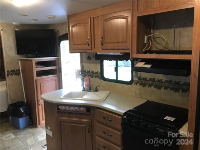 This 2008 31' Jayco RV w/ a custom-built covered structure on The Tillery Tradition Country Club in North Carolina - for sale on GolfHomes.com, golf home, golf lot