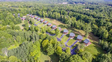 Charming and cozy, this Beaver Creek Resort cabin offers the on The Loon Golf Resort in Michigan - for sale on GolfHomes.com, golf home, golf lot