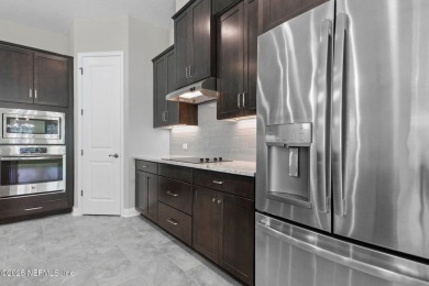 This luxury four bedroom, three bath upgraded home on a wooded on Amelia National Golf and Country Club in Florida - for sale on GolfHomes.com, golf home, golf lot