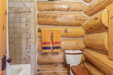 An extraordinary log home surrounded by mature trees and on Red Lodge Golf Club in Montana - for sale on GolfHomes.com, golf home, golf lot