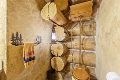 An extraordinary log home surrounded by mature trees and on Red Lodge Golf Club in Montana - for sale on GolfHomes.com, golf home, golf lot