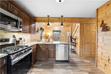 Discover this inviting Beaver Creek Resort cabin, offering the on The Loon Golf Resort in Michigan - for sale on GolfHomes.com, golf home, golf lot