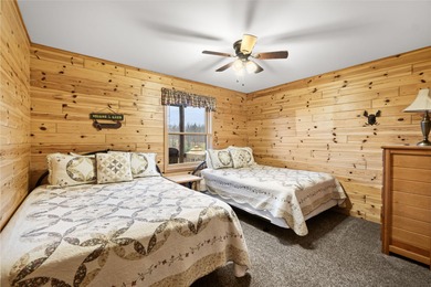 Discover this inviting Beaver Creek Resort cabin, offering the on The Loon Golf Resort in Michigan - for sale on GolfHomes.com, golf home, golf lot