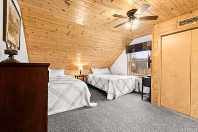 Discover this inviting Beaver Creek Resort cabin, offering the on The Loon Golf Resort in Michigan - for sale on GolfHomes.com, golf home, golf lot