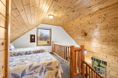 Discover this inviting Beaver Creek Resort cabin, offering the on The Loon Golf Resort in Michigan - for sale on GolfHomes.com, golf home, golf lot