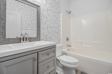 Set on a desirable corner lot, this spacious 4-bedroom, 3-bath on Myrtle Beach National Golf Course in South Carolina - for sale on GolfHomes.com, golf home, golf lot