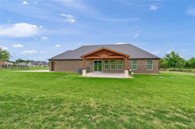 Located near the charming city of Denison, TX, 31 Golf Walk Cir on Denison Country Club in Texas - for sale on GolfHomes.com, golf home, golf lot