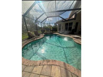 HEATED POOL & SPA WITH CASCADING WATERFALL! Welcome to Belle on Estero Country Club in Florida - for sale on GolfHomes.com, golf home, golf lot