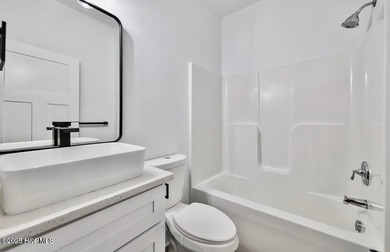 Discover a home that flawlessly blends modern sophistication on Carolina Shores Golf Course in North Carolina - for sale on GolfHomes.com, golf home, golf lot