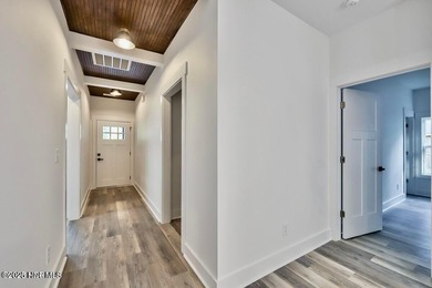 Discover a home that flawlessly blends modern sophistication on Carolina Shores Golf Course in North Carolina - for sale on GolfHomes.com, golf home, golf lot