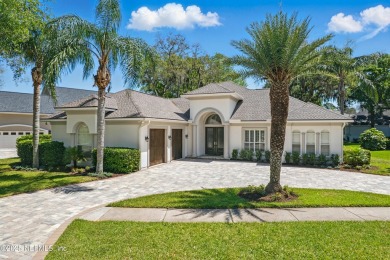 Nestled beneath a canopy of mature oak trees in the gated on Queens Harbour Yacht and Country Club in Florida - for sale on GolfHomes.com, golf home, golf lot