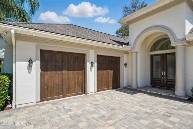 Nestled beneath a canopy of mature oak trees in the gated on Queens Harbour Yacht and Country Club in Florida - for sale on GolfHomes.com, golf home, golf lot