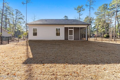 Discover a home that flawlessly blends modern sophistication on Carolina Shores Golf Course in North Carolina - for sale on GolfHomes.com, golf home, golf lot