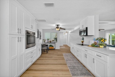 Picture yourself in a tropical oasis, where lush landscapes and on Gulf Harbors Golf Course in Florida - for sale on GolfHomes.com, golf home, golf lot