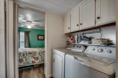 Situated on an oversized lot, this clean, bright, and move-in on Barefoot Resort and Golf Club  in South Carolina - for sale on GolfHomes.com, golf home, golf lot