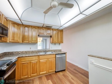 BRAND NEW VINYL FLOORING, NEVER-USED TOP-LINE SS APPLIANCES W/ on Wynmoor Golf Course in Florida - for sale on GolfHomes.com, golf home, golf lot