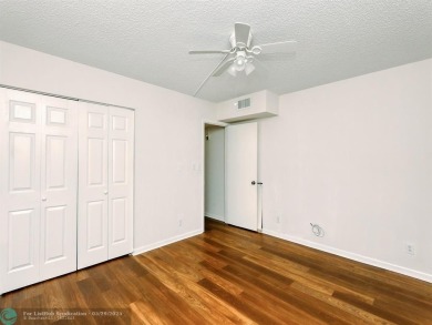 BRAND NEW VINYL FLOORING, NEVER-USED TOP-LINE SS APPLIANCES W/ on Wynmoor Golf Course in Florida - for sale on GolfHomes.com, golf home, golf lot