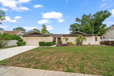 Welcome to this large ranch style, 4-bedroom, 2.5-bathroom home on Feather Sound Country Club in Florida - for sale on GolfHomes.com, golf home, golf lot