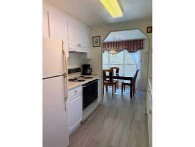 This lovely, manufactured home is on leased land in Lake on Pine Lakes Country Club in Florida - for sale on GolfHomes.com, golf home, golf lot