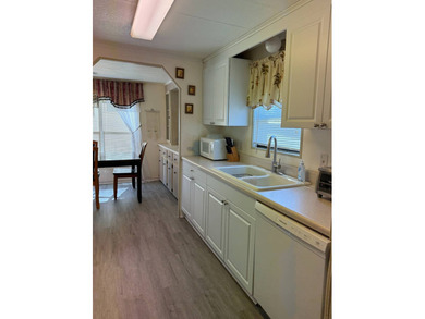 This lovely, manufactured home is on leased land in Lake on Pine Lakes Country Club in Florida - for sale on GolfHomes.com, golf home, golf lot