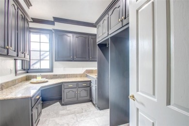 Welcome to a refined residence nestled on the prestigious west on Oak Tree National Golf and Country Club in Oklahoma - for sale on GolfHomes.com, golf home, golf lot