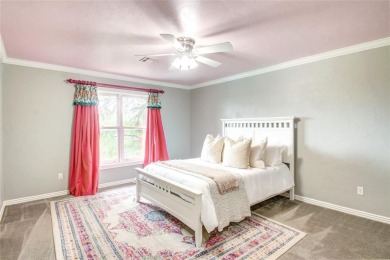Welcome to a refined residence nestled on the prestigious west on Oak Tree National Golf and Country Club in Oklahoma - for sale on GolfHomes.com, golf home, golf lot