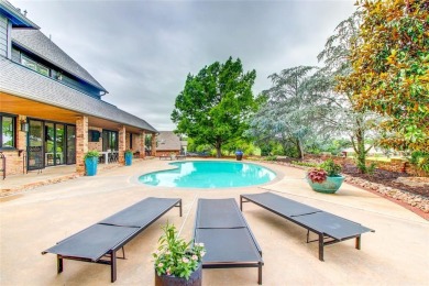 Welcome to a refined residence nestled on the prestigious west on Oak Tree National Golf and Country Club in Oklahoma - for sale on GolfHomes.com, golf home, golf lot